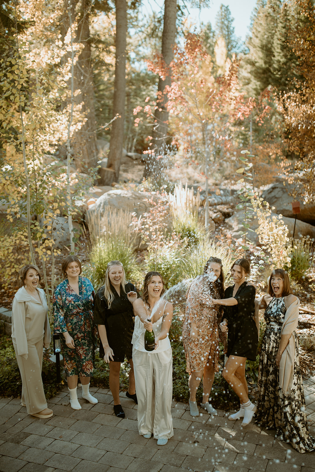 Bridesmaids celebrating with champagne spray at outdoor wedding - DJs In Reno Tahoe wedding DJ Bridesmaids celebrating with champagne spray at outdoor wedding - DJs In Reno Tahoe wedding DJ