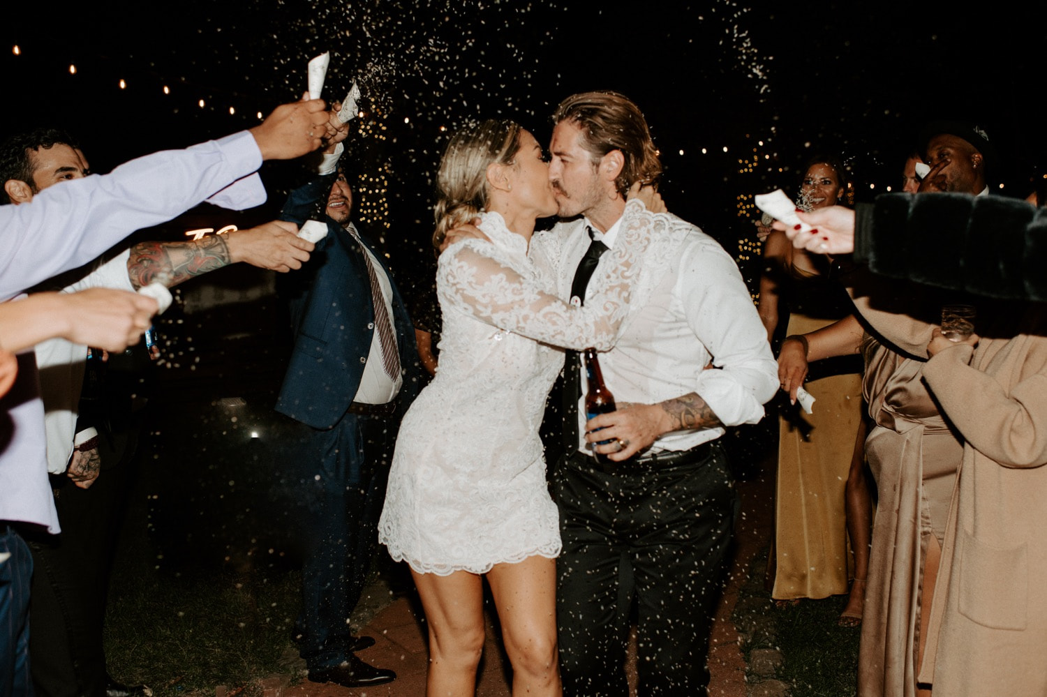 Wedding couple kissing with confetti