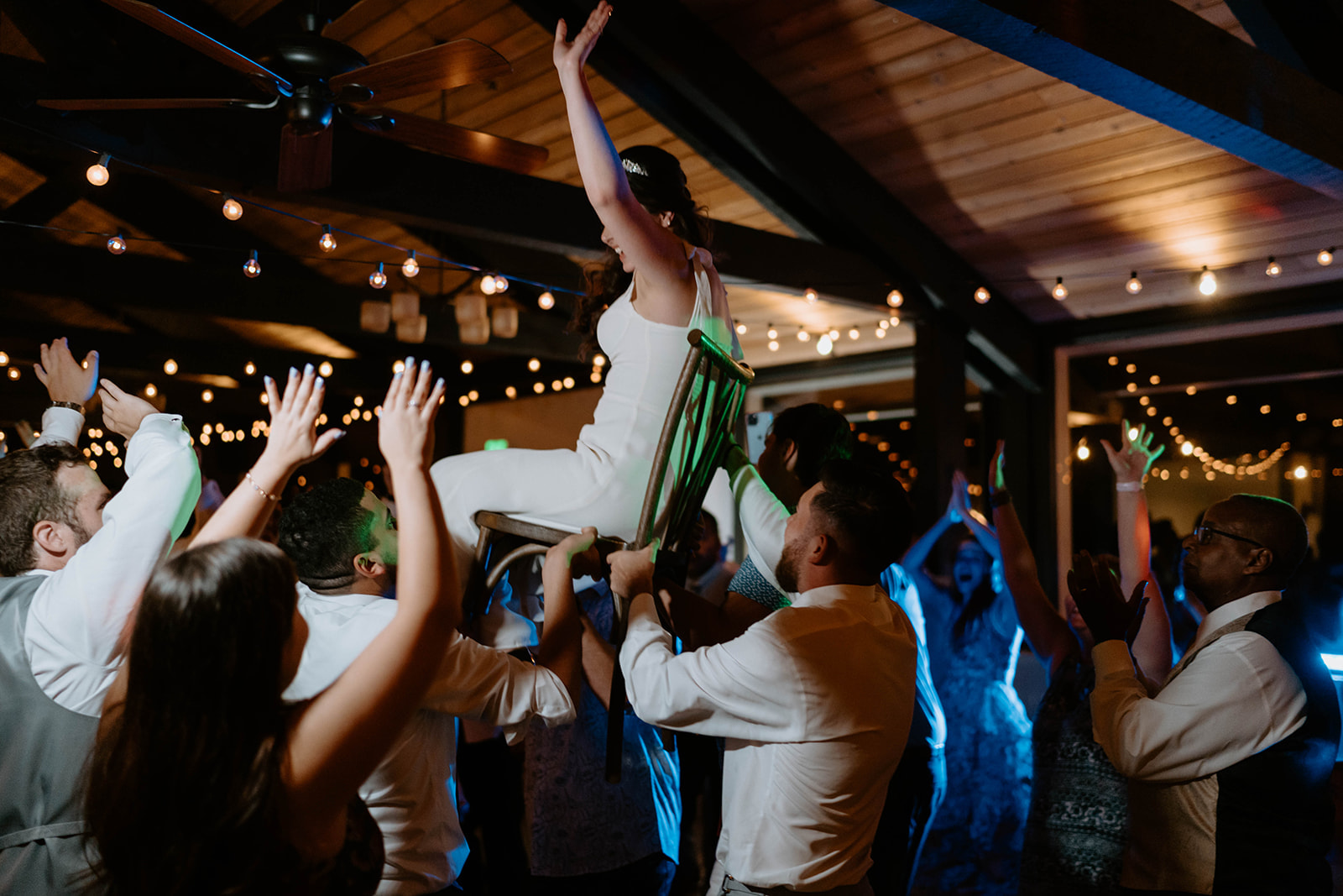 Bride crowd surfing at wedding reception