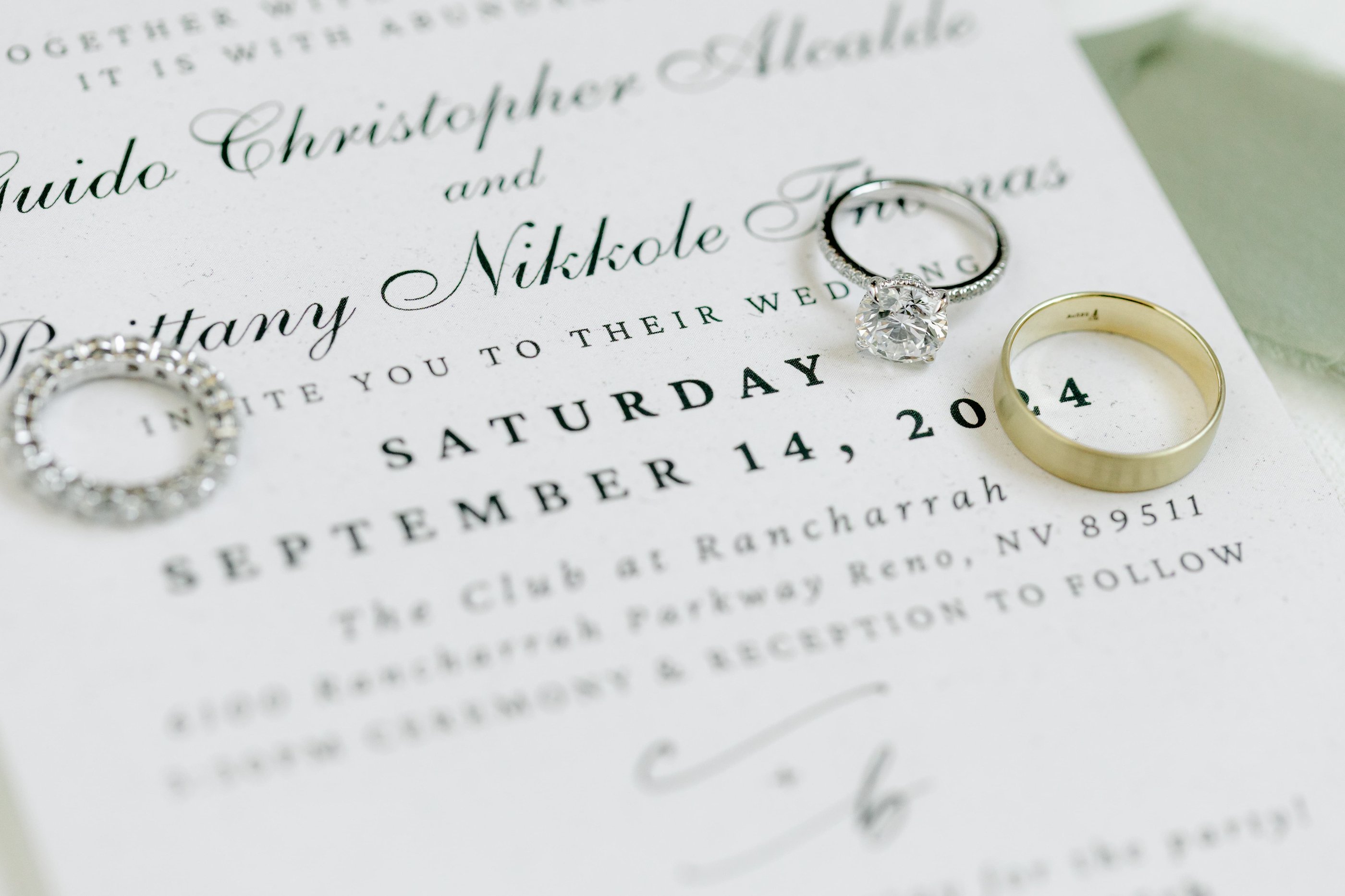 Wedding rings and invitation detail showcasing elegant Reno wedding planning