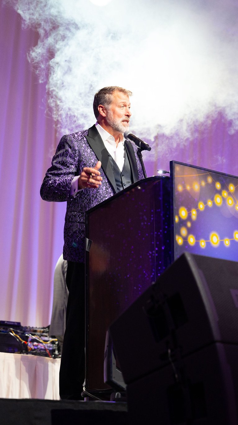A speaker at the podium on stage at Renown Health's Celebrate Amazing at the Peppermill in 2024