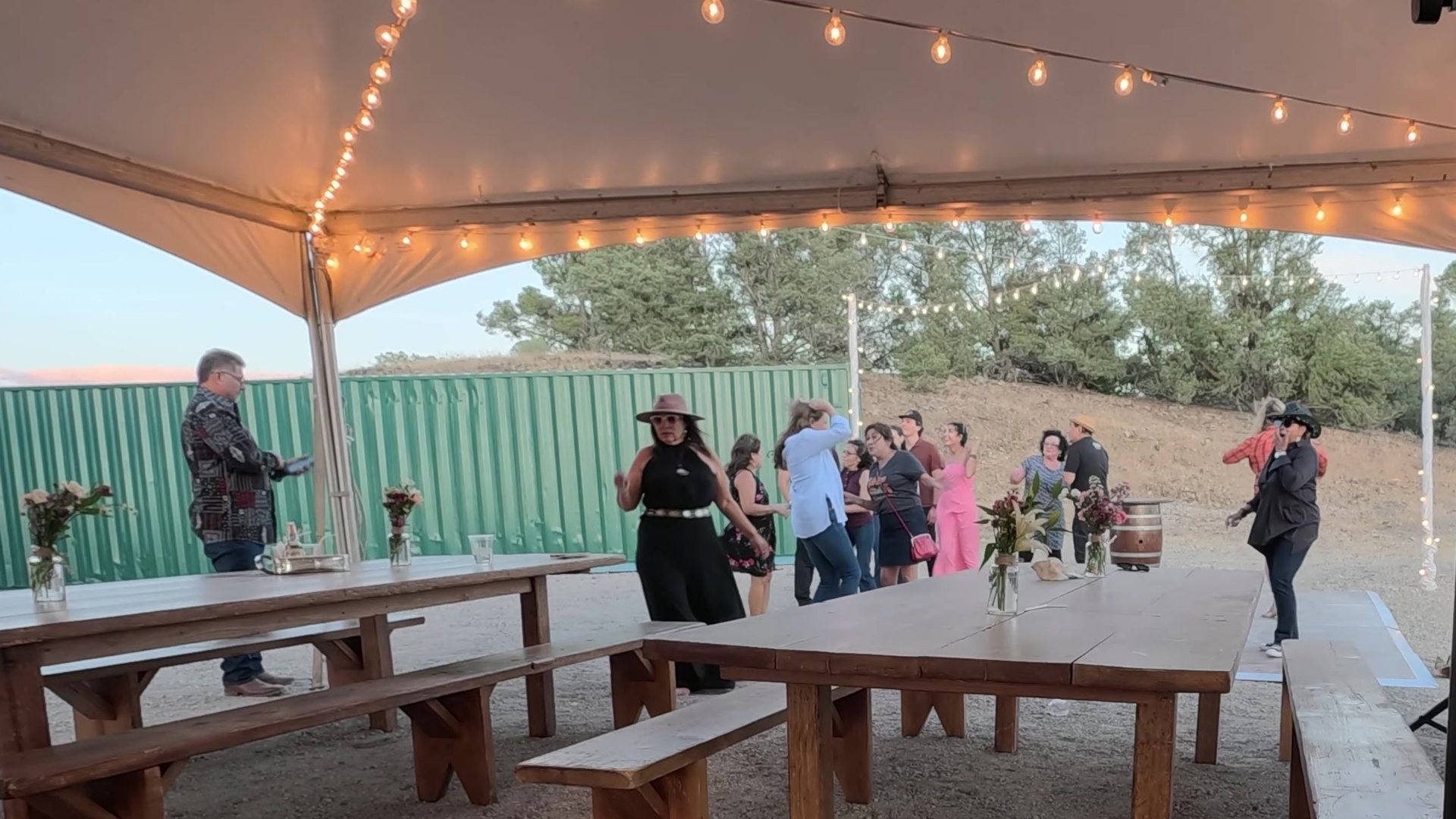 Guests dancing under the string lights of the white tent at Alice’s 60th birthday party in the Virginia City Highlands