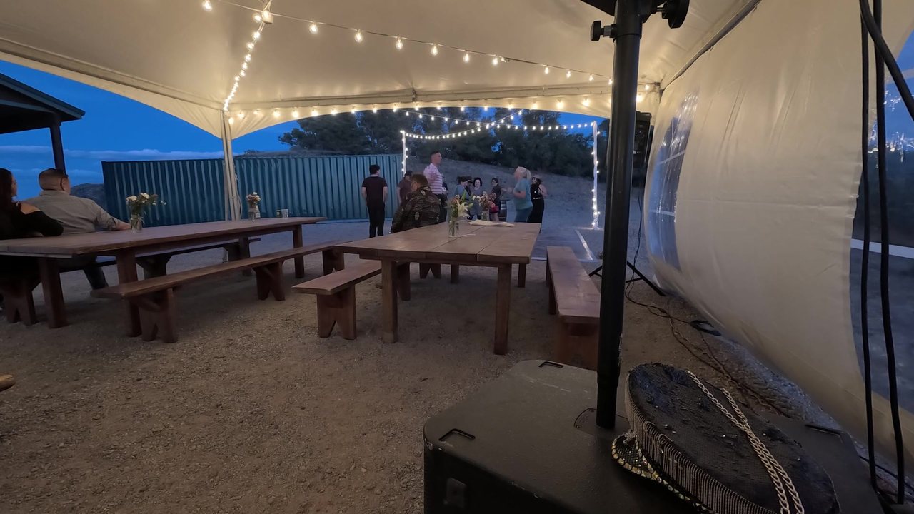 The tent glowing under its string lights after sunset