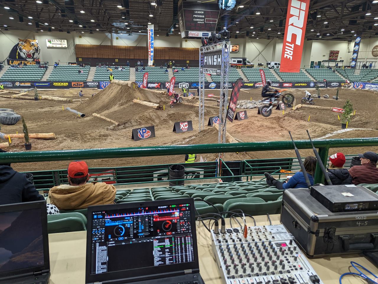 A rider jumping near the finish line beside the DJ booth at AMA EnduroCross, Reno Livestock Events Center