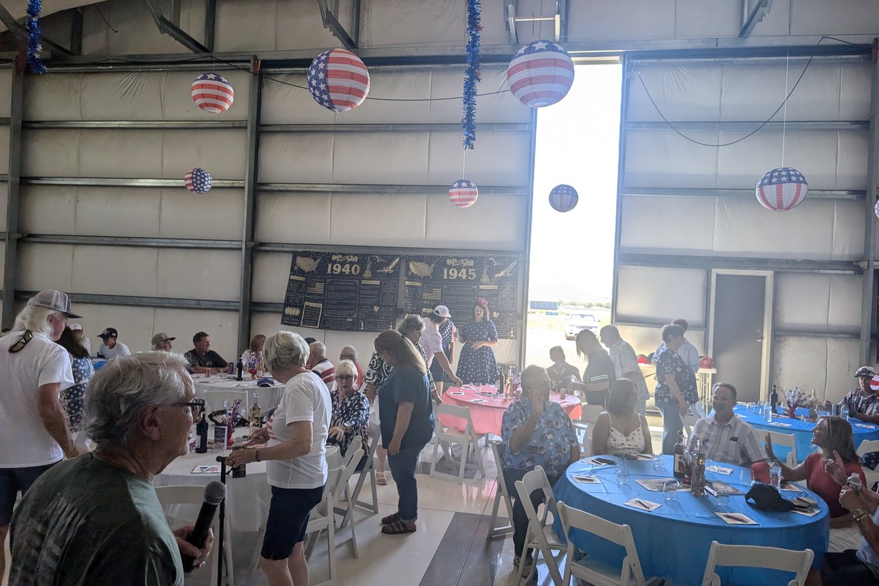 Guests arriving and finding their seats at the blue and red tables