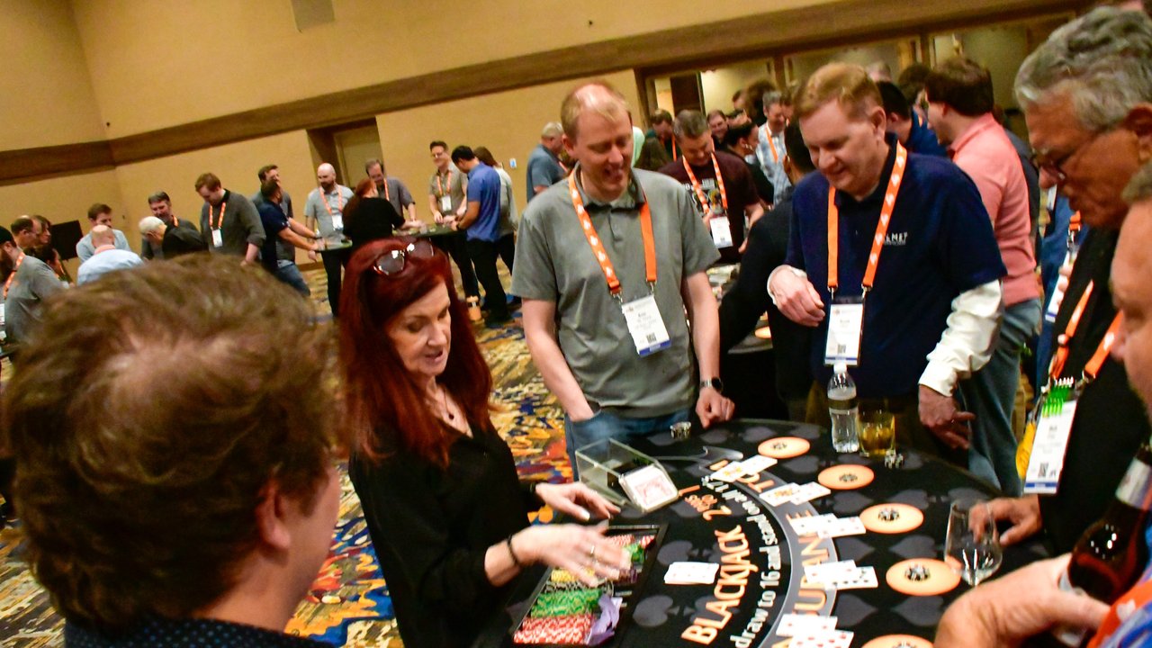 AMUG guests playing blackjack at a crowded table