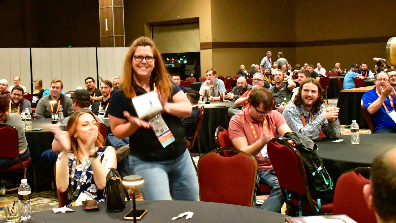 AMUG guests cheering at their tables during the raffle