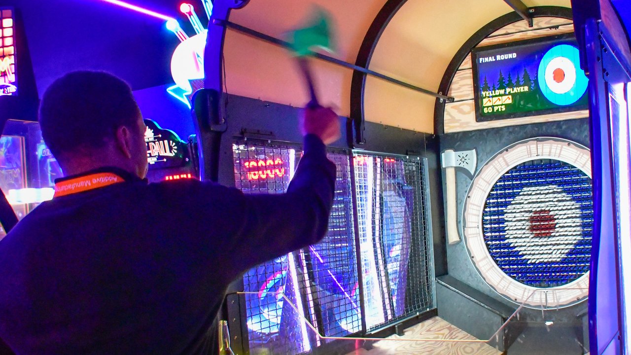 An AMUG guest throwing at a lit arcade target game