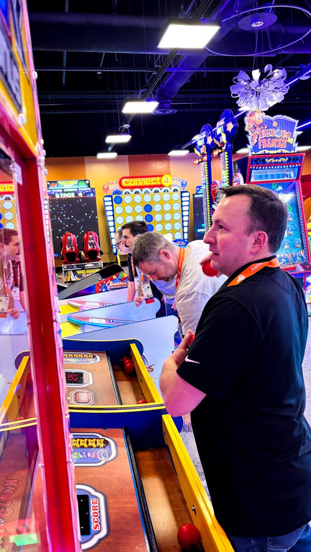 AMUG guests rolling balls at the skee ball lanes