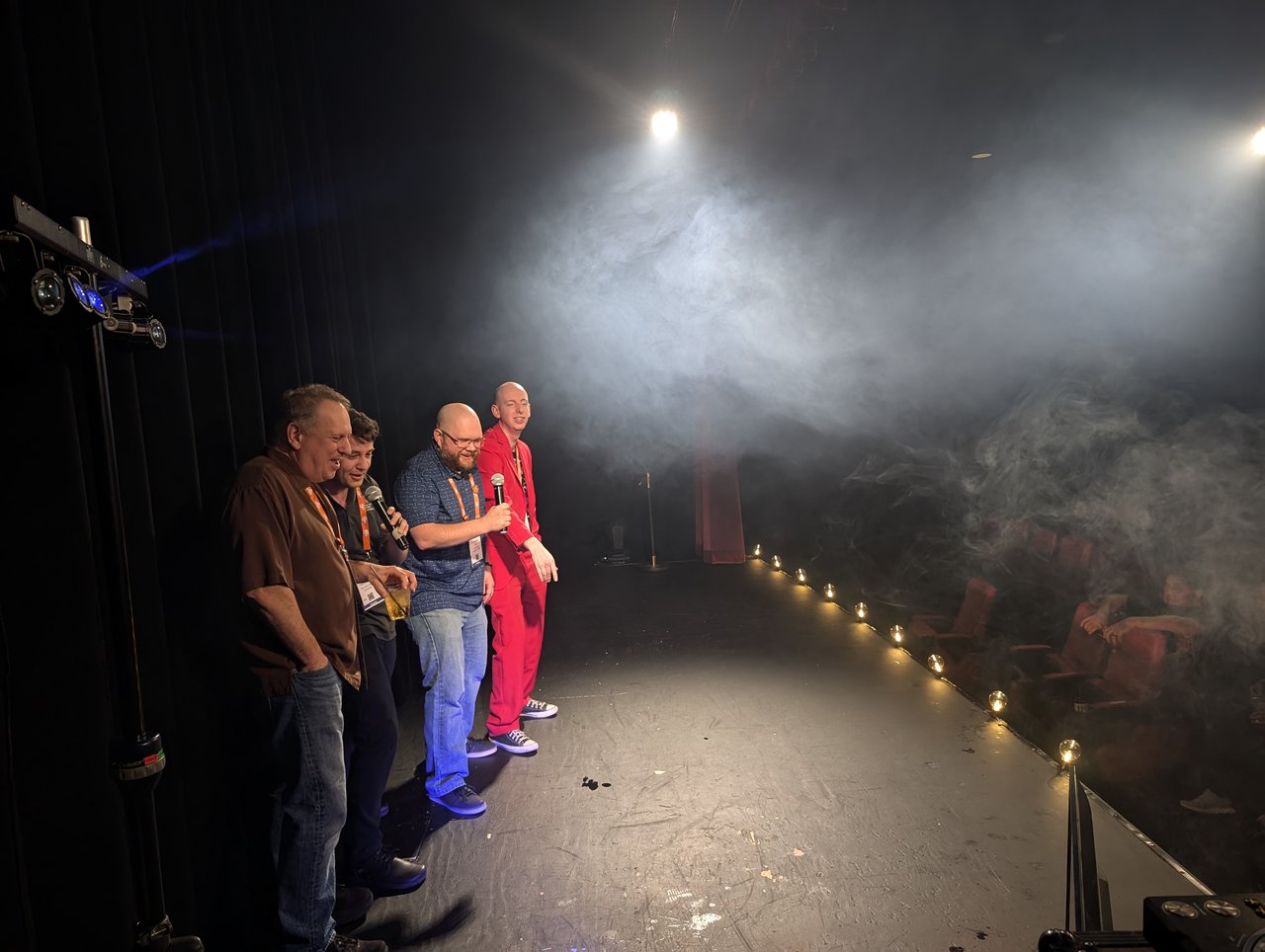 A group of AMUG guests singing karaoke together on the foggy White Rabbit stage