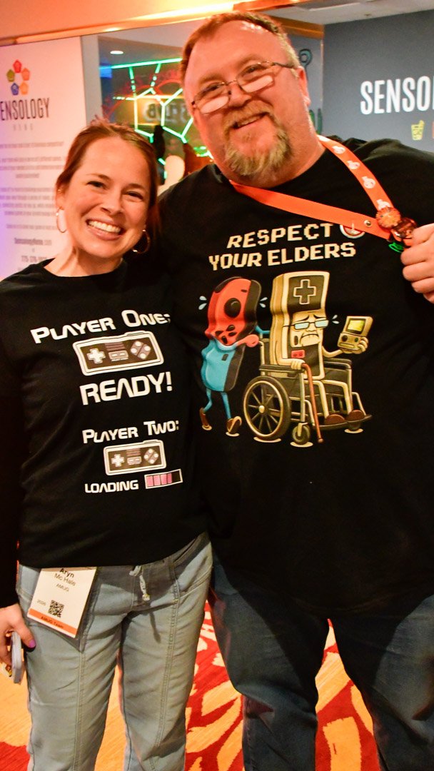 Two AMUG guests in matching Player One and Player Two shirts