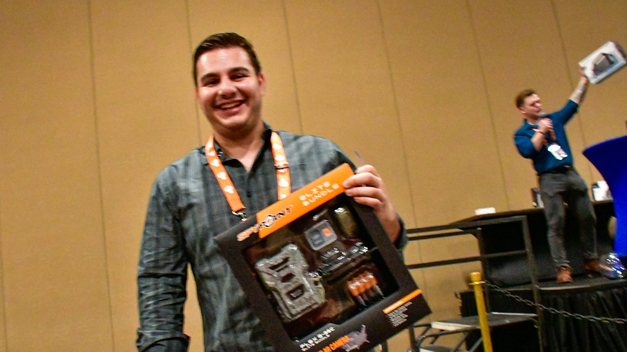 A smiling AMUG guest holding up the tool set he won