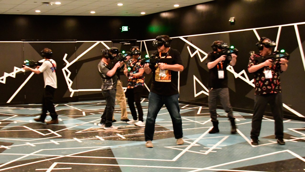 AMUG guests in VR headsets playing laser tag in the arena