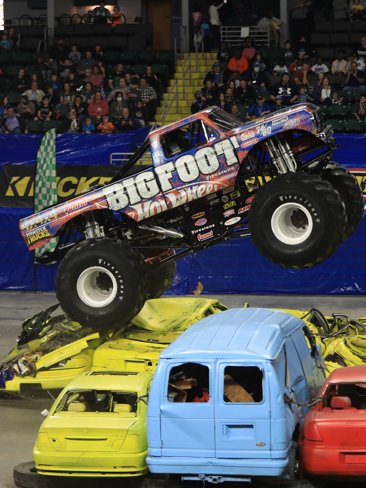 Bigfoot jumping crushed cars at a KICKER Monster Truck Show