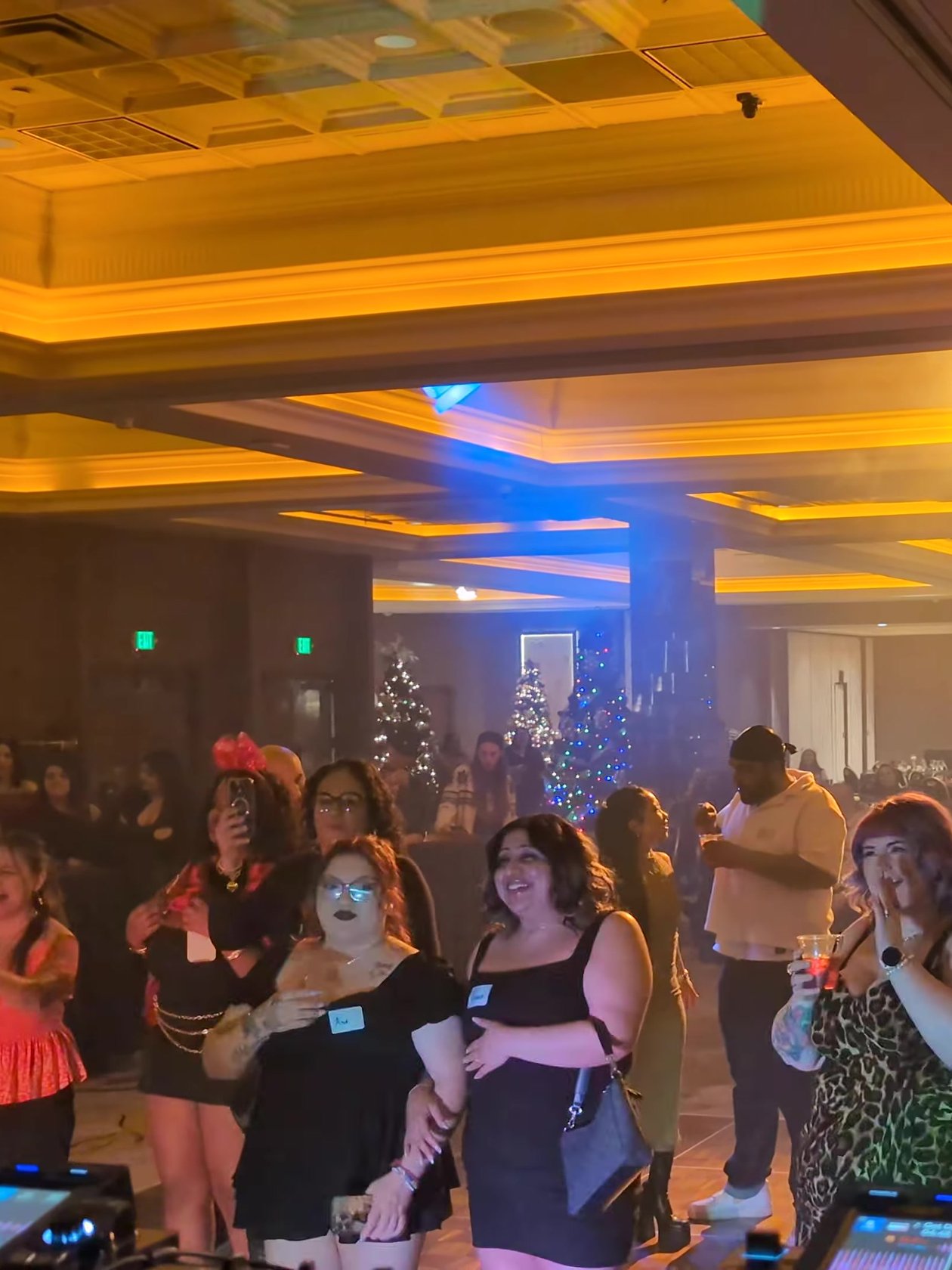 Sierra Air guests cheering on the dance floor at their holiday party in the Peppermill Naples Ballroom