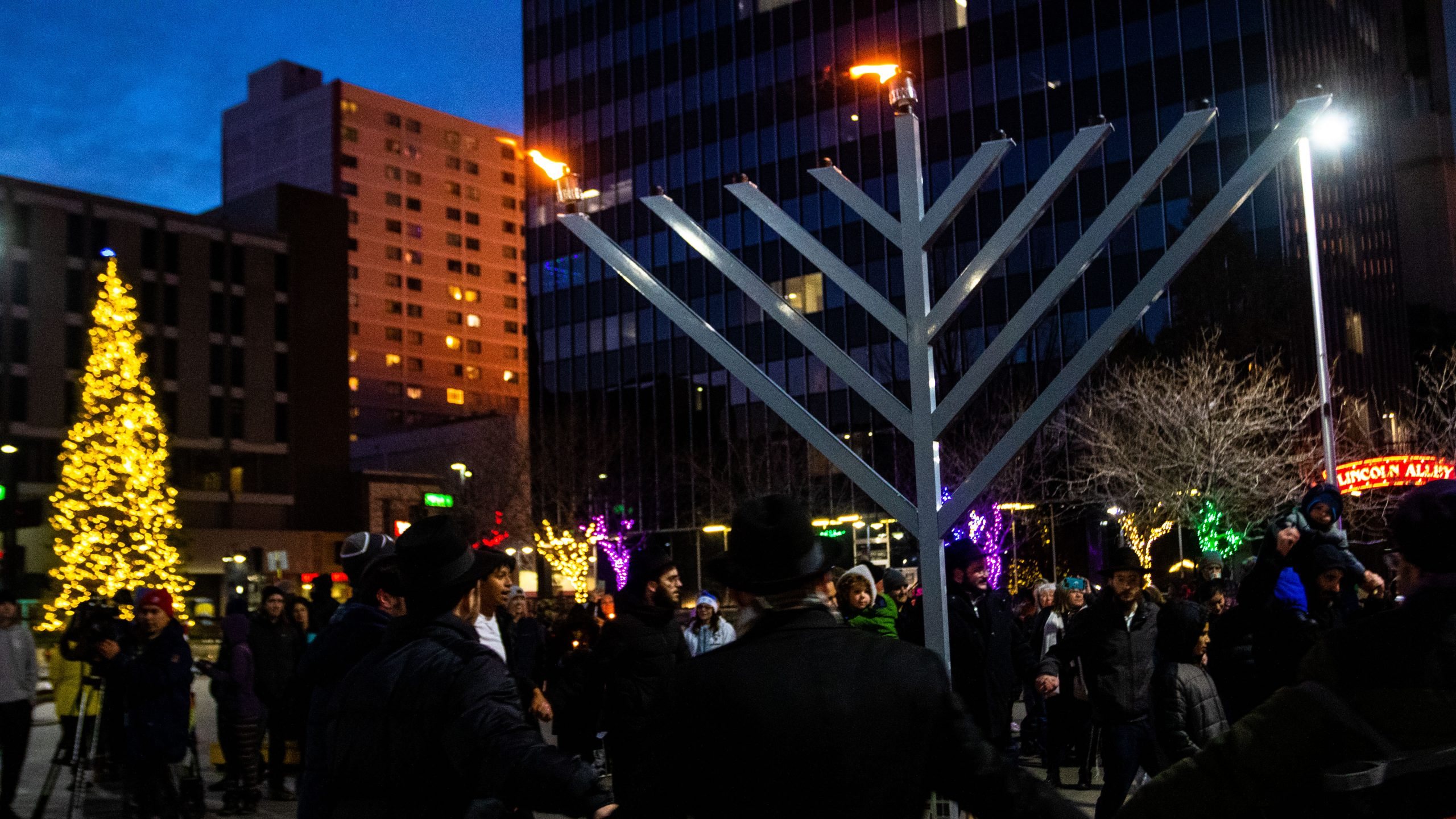 Hora dancing under the lit menorah in City Plaza, downtown Reno