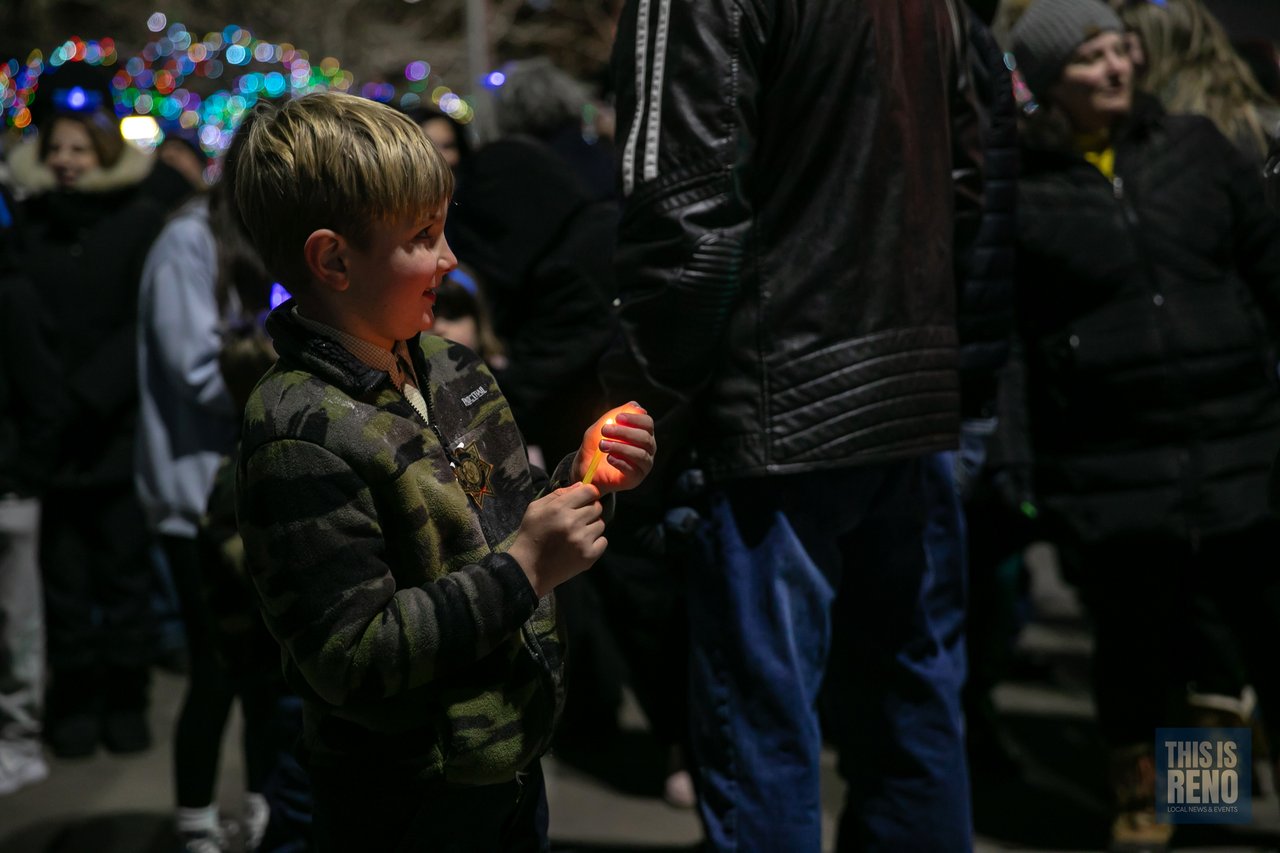A boy smiles in the crowd after the lighting