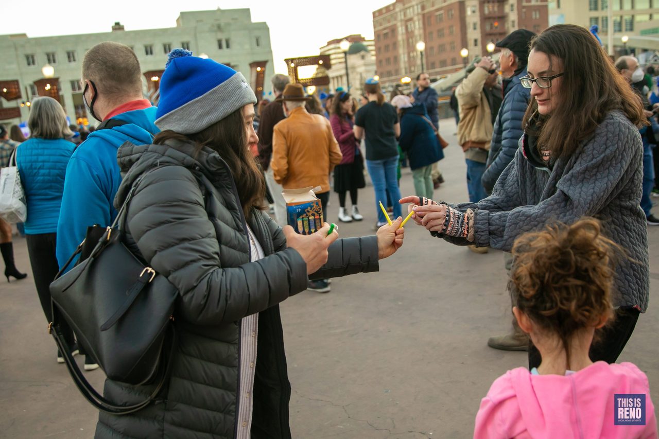 Volunteers handing out candles to families