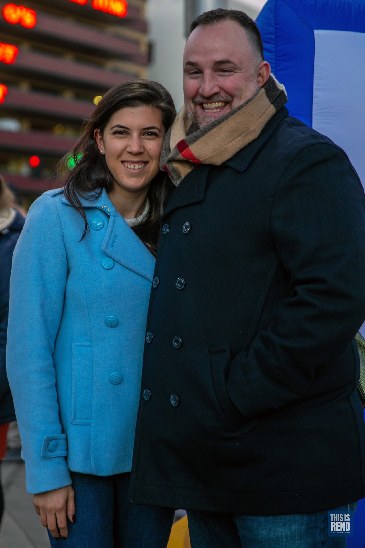 A couple smiles together in City Plaza at the Chanukah Menorah Lighting