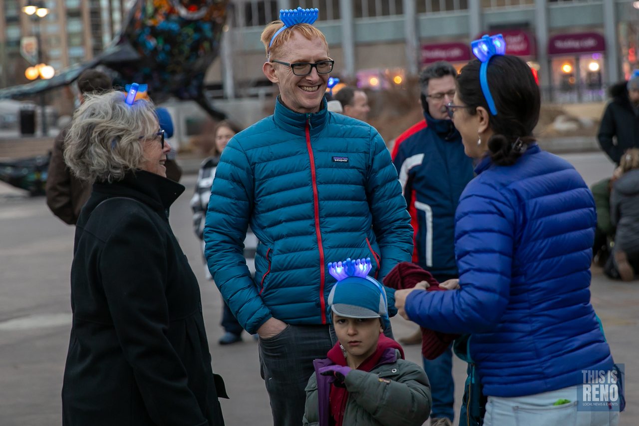 Families in light up menorah headbands at the Menorah Lighting