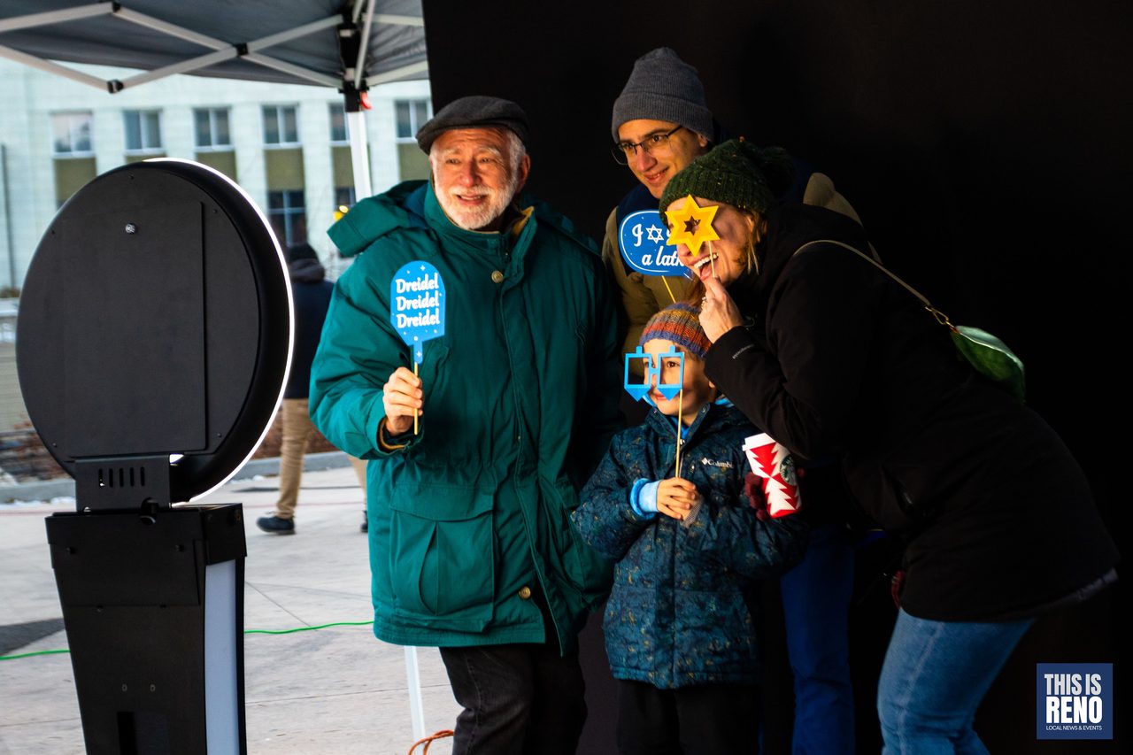 A family posing with Chanukah props at the photo booth