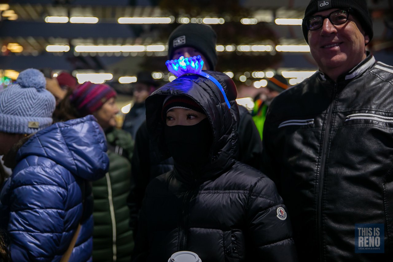 Friends bundled up against the cold in the crowd