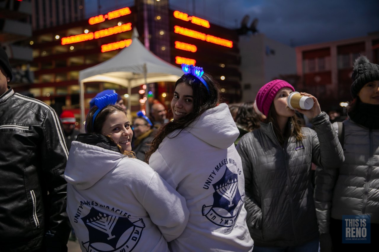 Friends in matching hoodies and menorah headbands