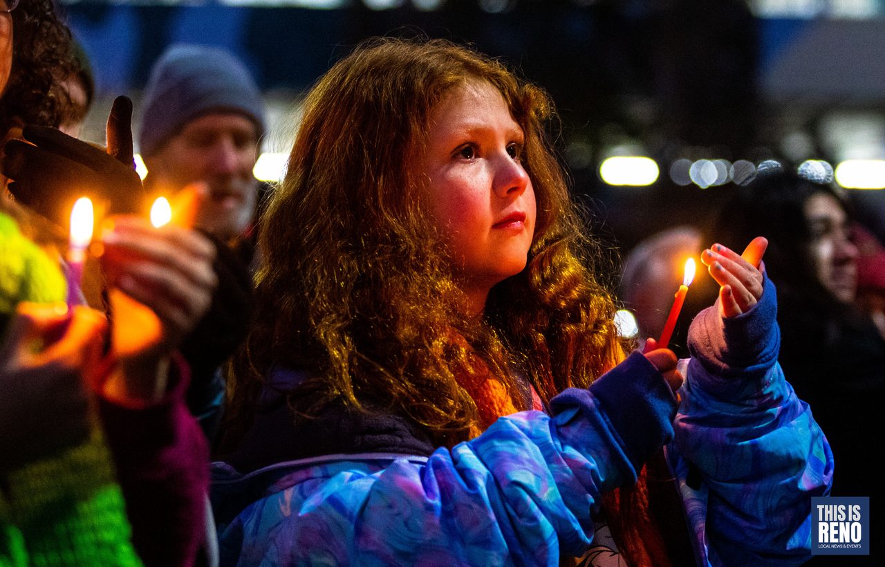 A girl watching her candle during the lighting