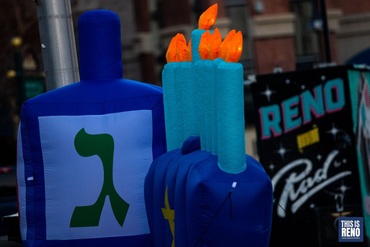 The inflatable dreidel and candles beside the Reno sign