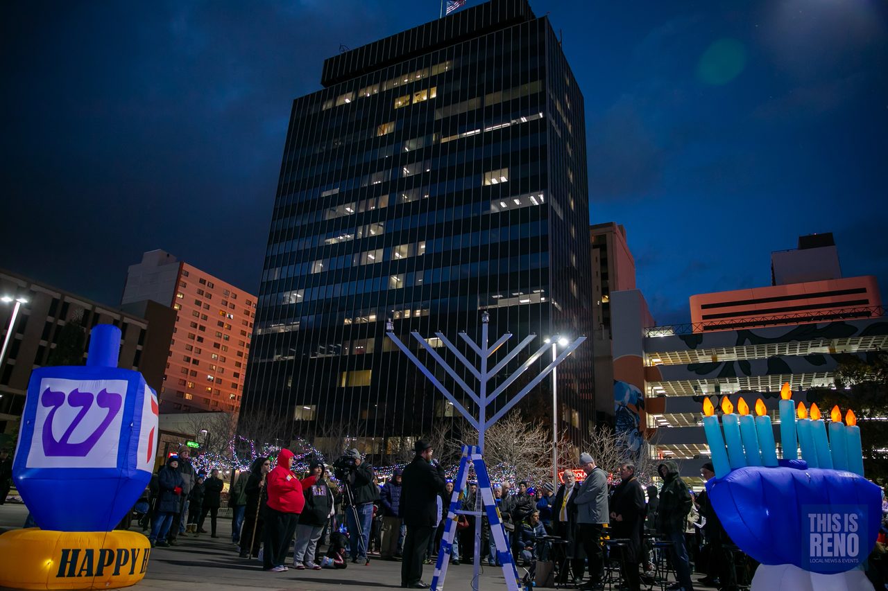 The menorah and dreidel inflatables under the downtown towers at night