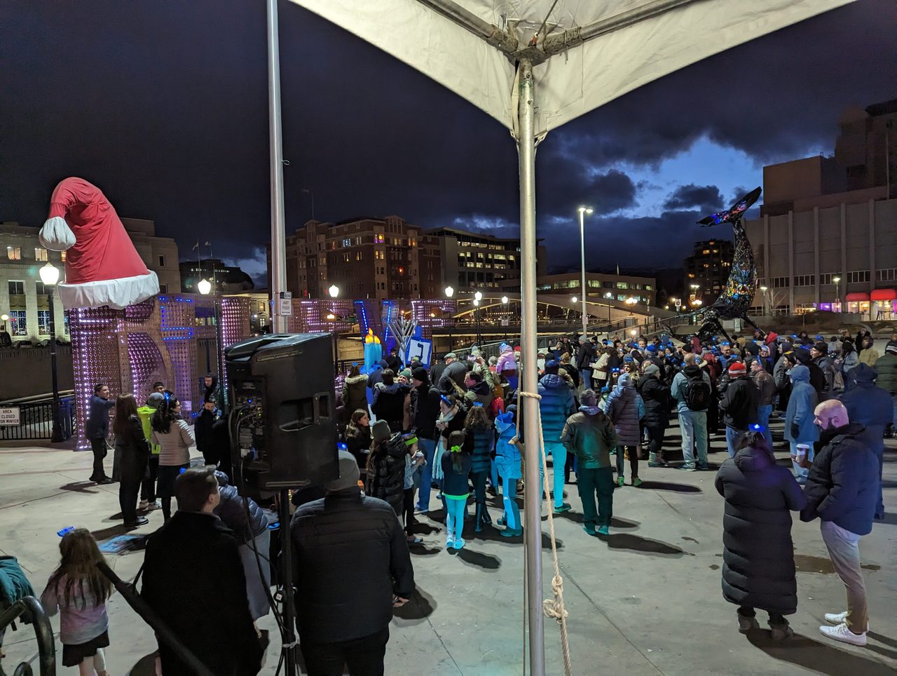 The crowd under the lights of City Plaza at night, seen from my DJ tent