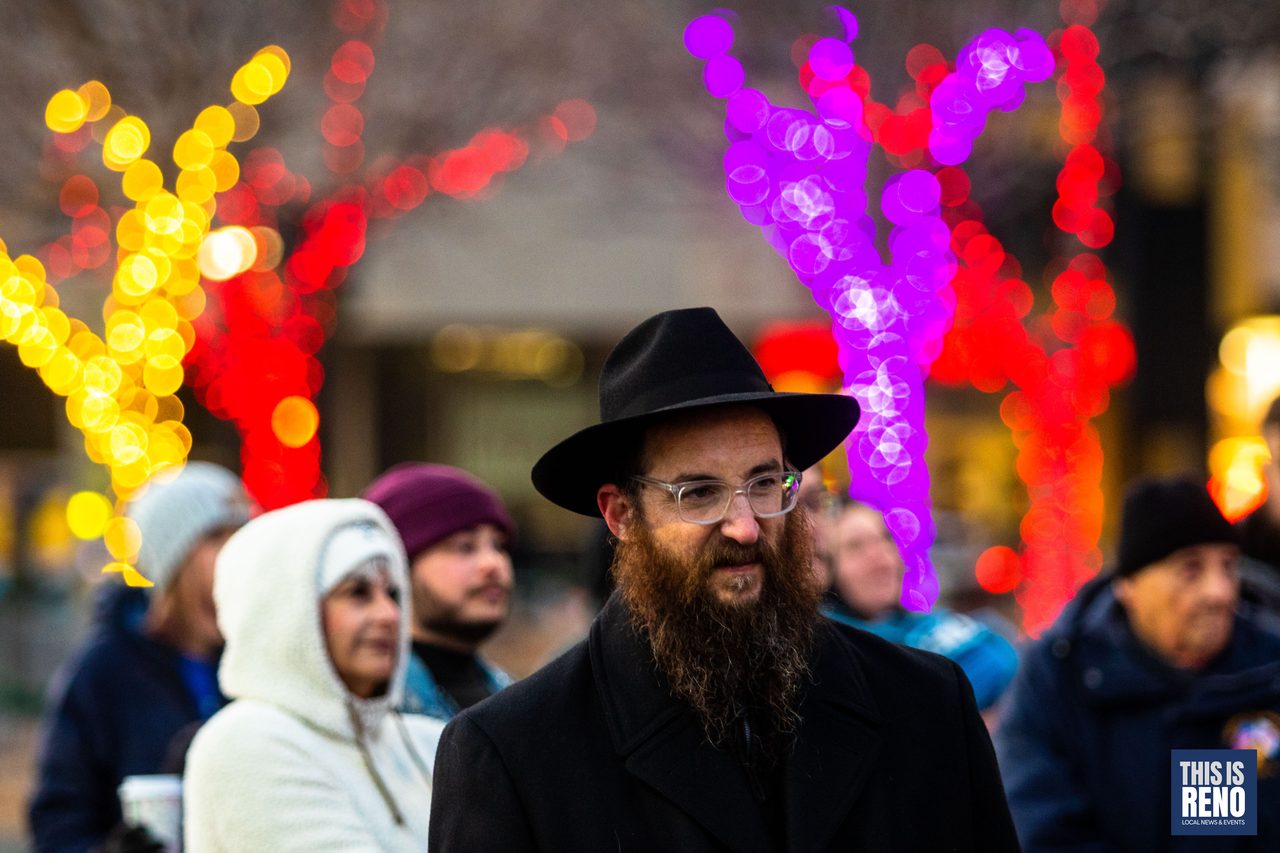 A rabbi smiling under the colored lights of City Plaza
