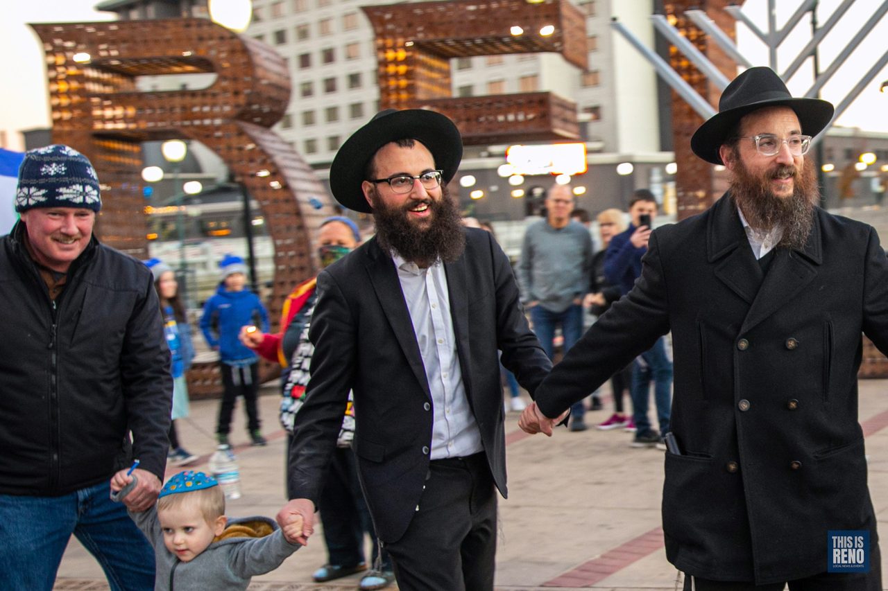 Two rabbis walking with families across City Plaza