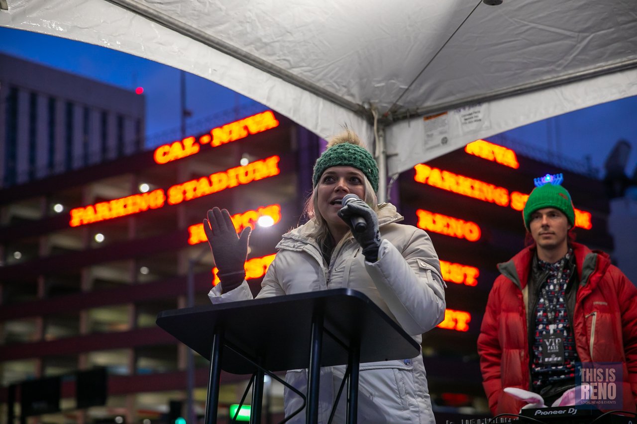 A singer performs at the microphone under the tent