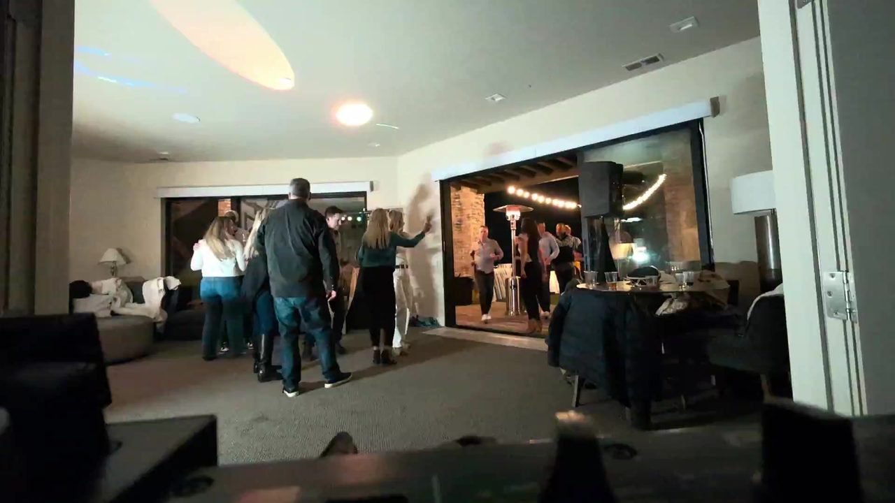 The dance floor with the patio string lights glowing through the doors