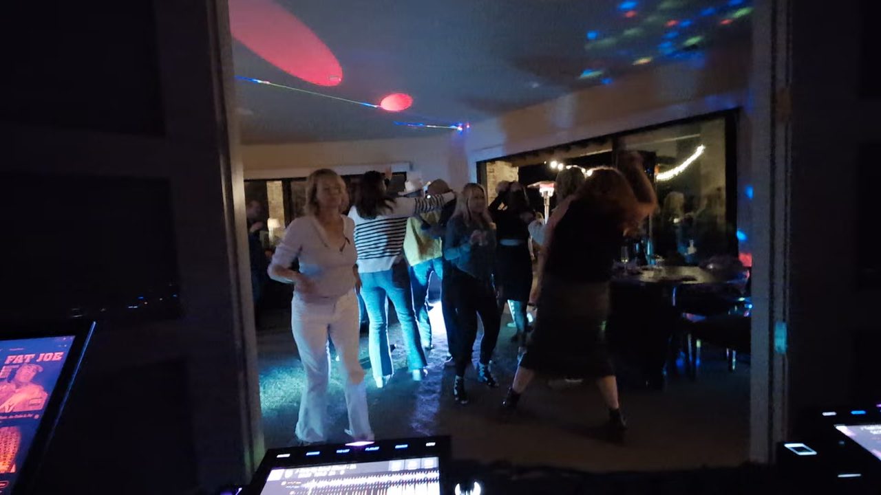 Guests dancing under the party lights in the living room