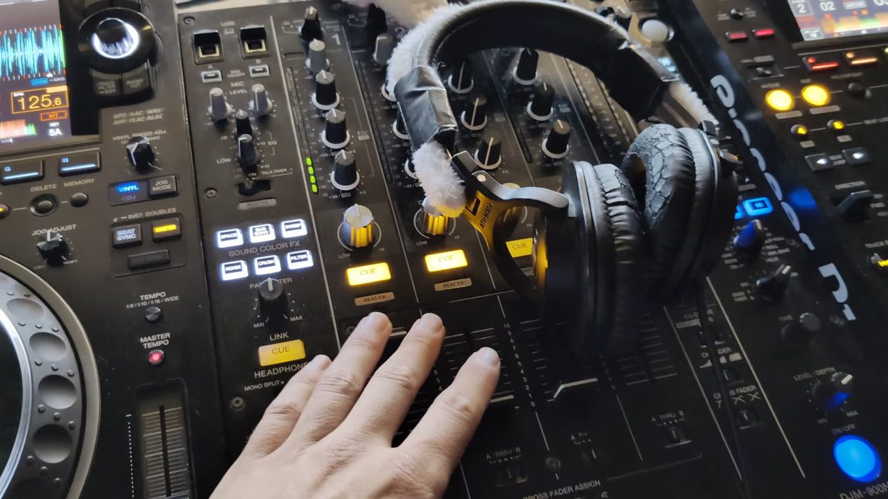The DJ mixer and headphones set up inside the house