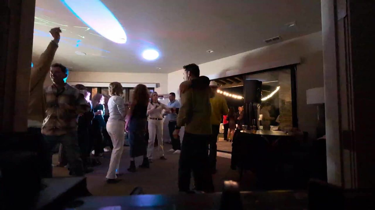 Guests with their hands up on the dance floor