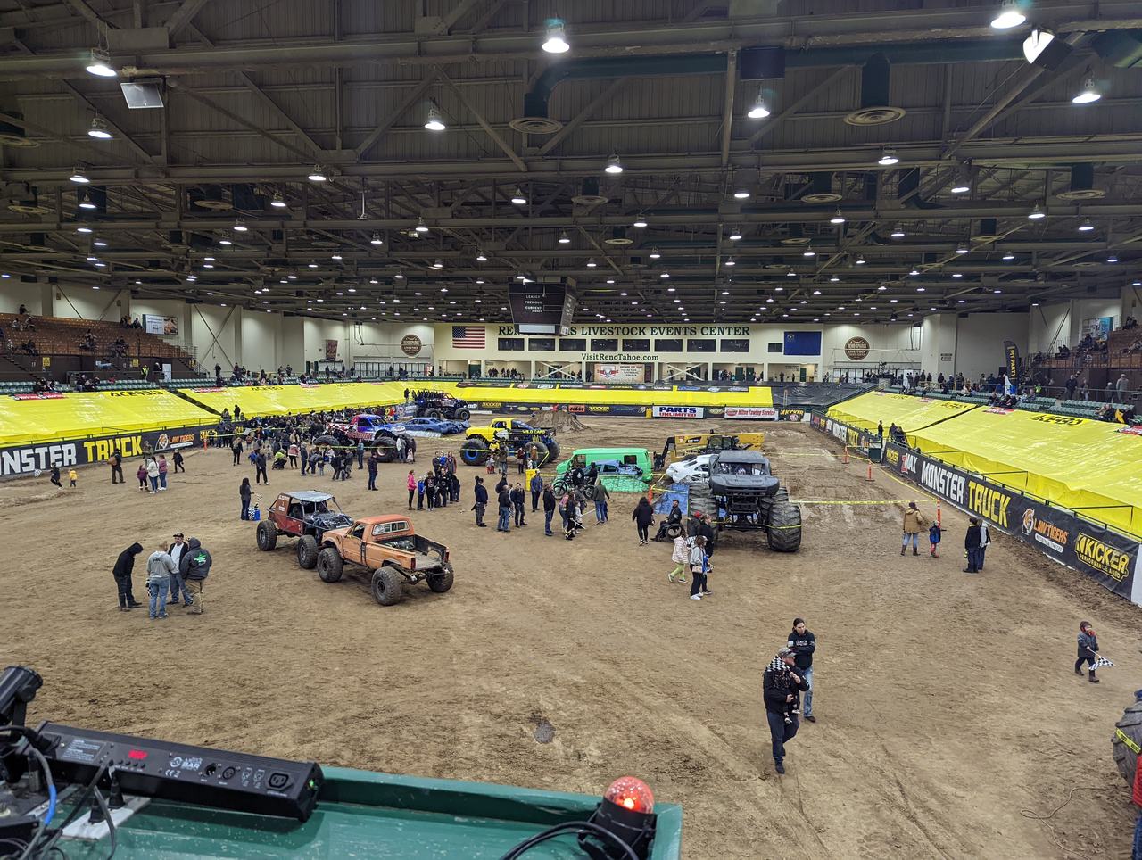 Families walking the track among the monster trucks during the Saturday pit party