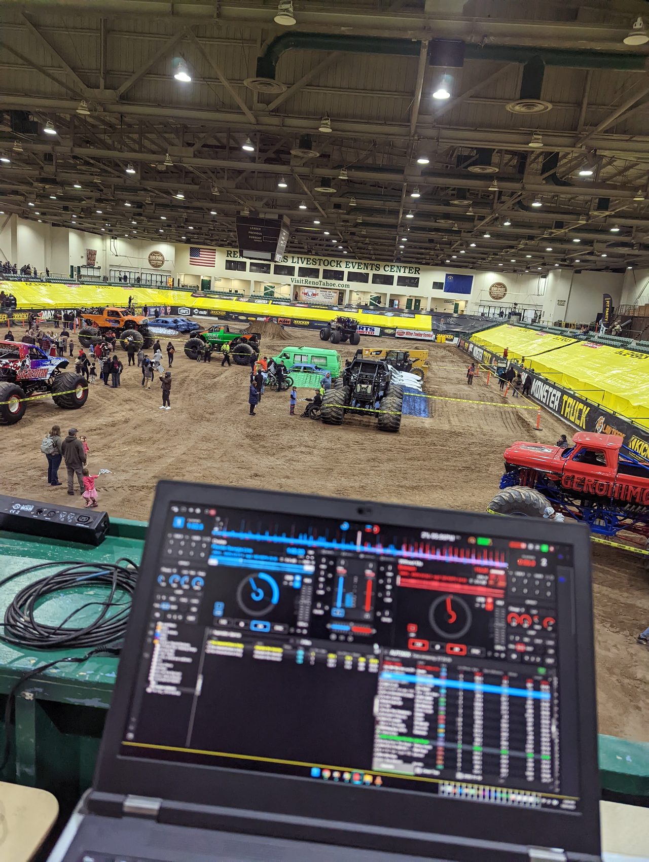 My laptop running VirtualDJ at the rail booth, with families walking among the trucks below