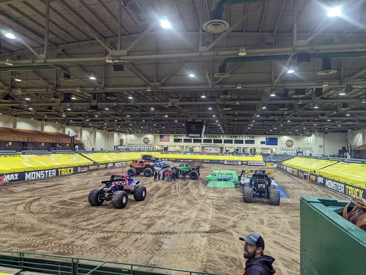 Monster trucks and crushed cars parked on the dirt track before the doors opened at the Reno Livestock Events Center