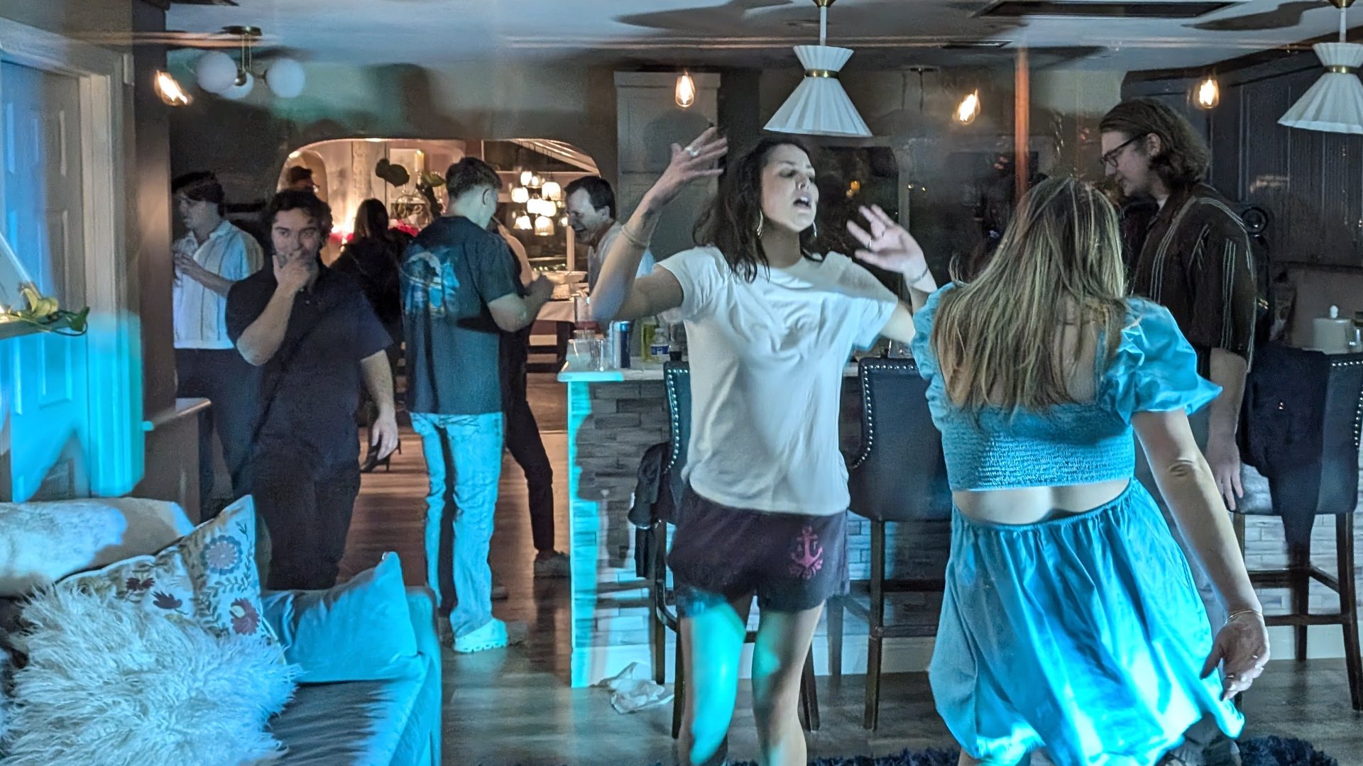 Guests dancing and singing in the living room at Niki’s 55th birthday party in Reno