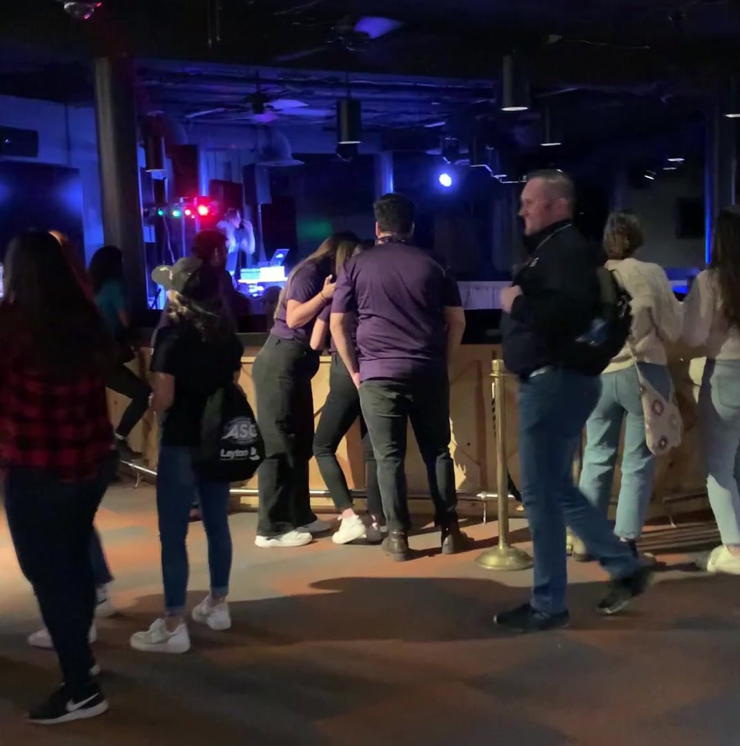Guests dancing by the DJ booth at the PENTA mixer at the Nugget