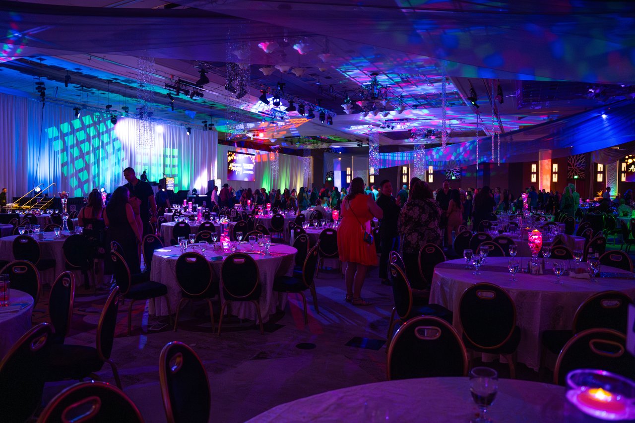 The ballroom glowing in blue and purple light during the party