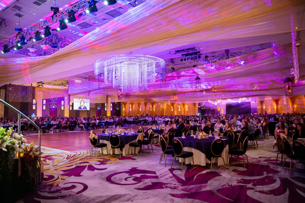 The Tuscany Ballroom filling up under the crystal chandelier and moving lights