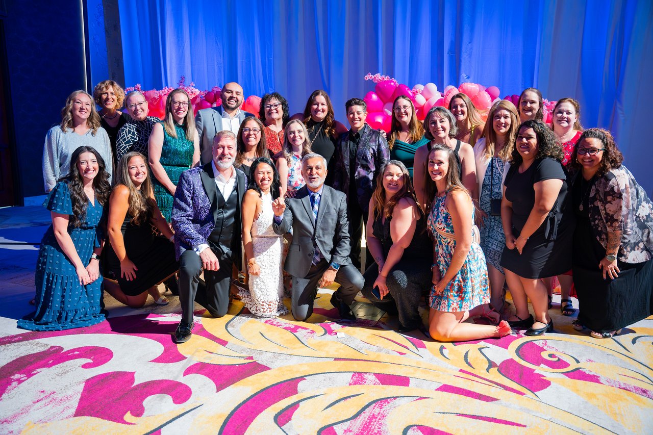 A big Renown team photo on the patterned carpet