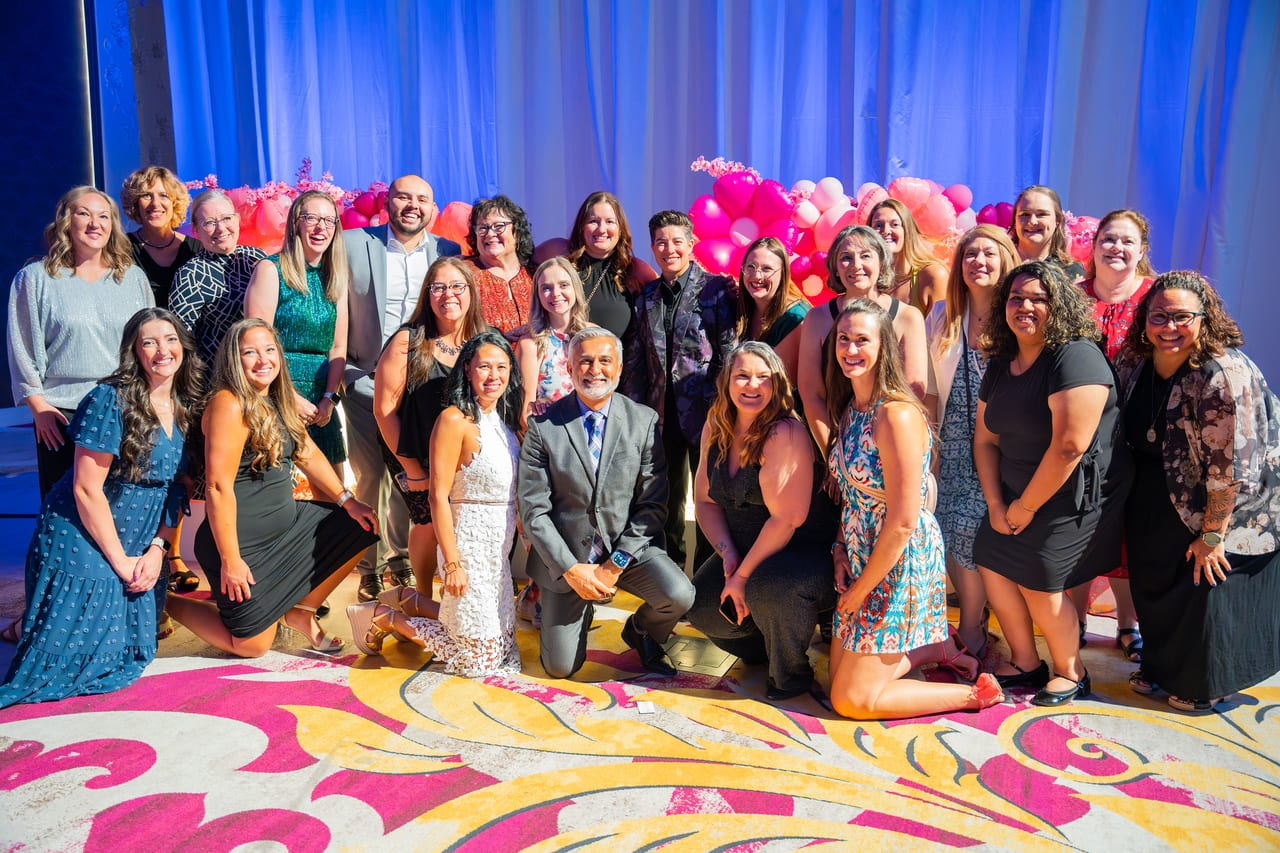 A big Renown team kneeling and standing together for their group photo