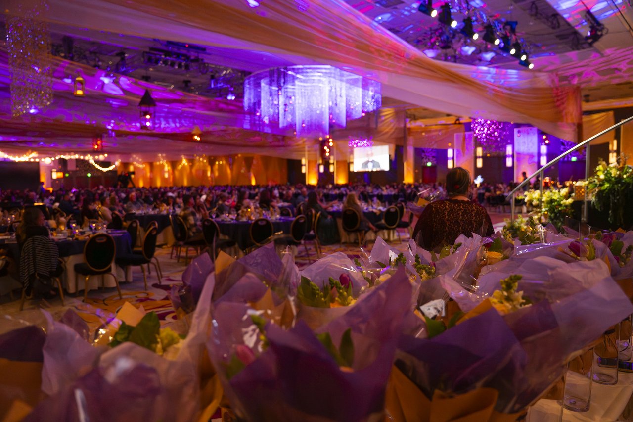 Bouquets lined up in front of the purple ballroom