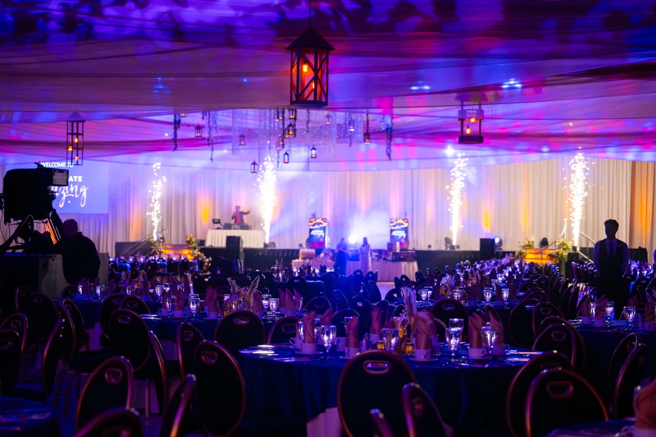 Cold spark fountains lighting up the stage over a ballroom of Renown tables