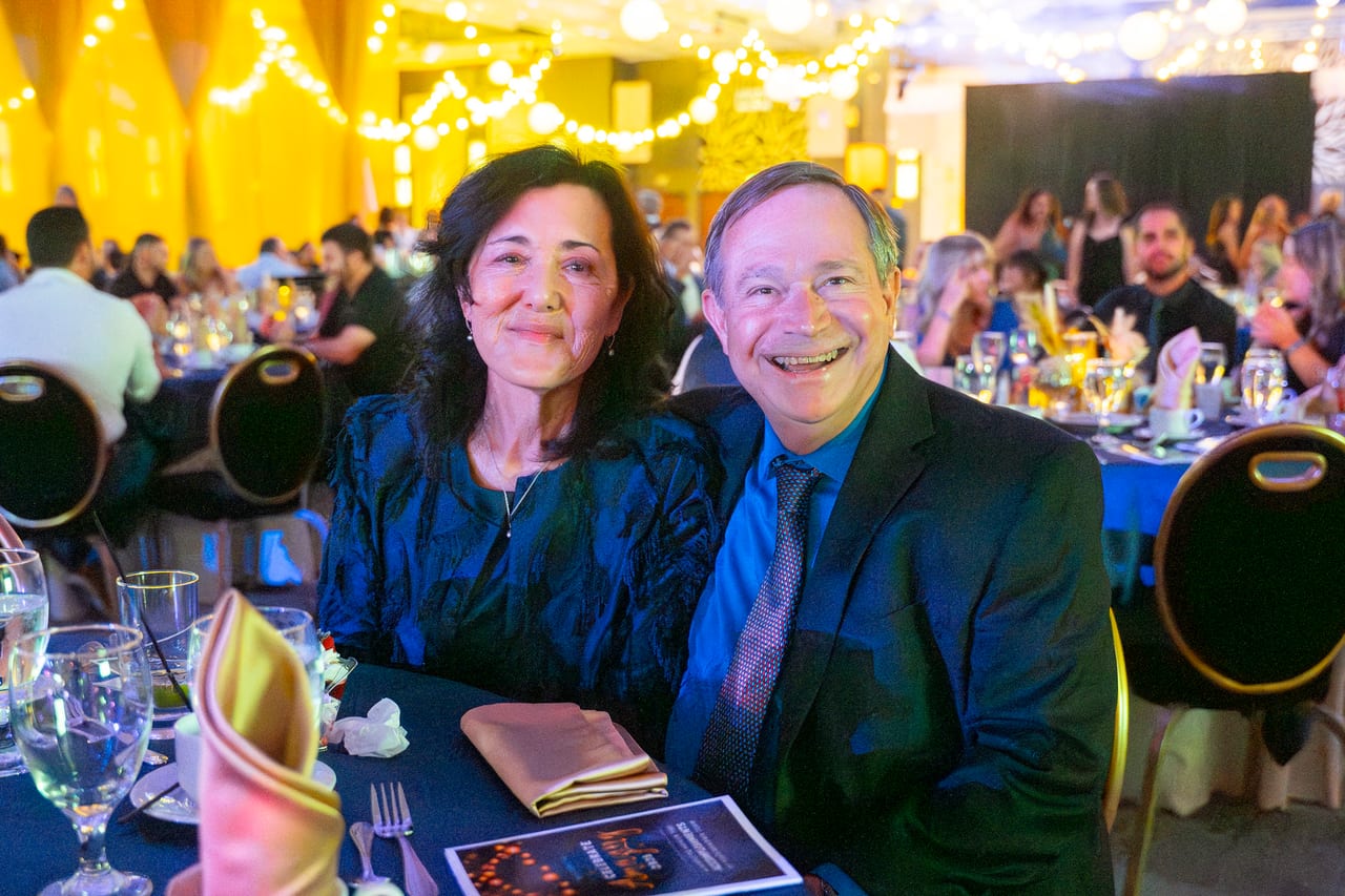 A Renown couple beaming at their candlelit table